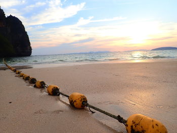 Scenic view of beach against sky during sunset