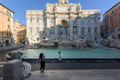 View of fountain in city against clear sky