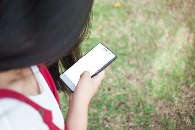 Low section of woman photographing with mobile phone