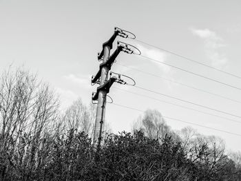 Low angle view of power lines against sky