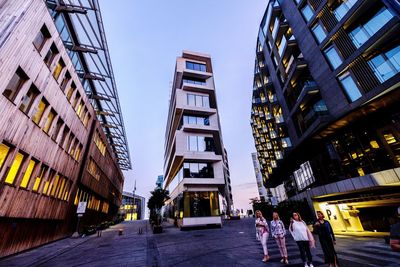 Low angle view of buildings in city against clear sky
