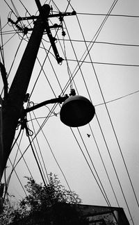 Low angle view of electricity pylon against sky