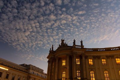 Low angle view of building against cloudy sky