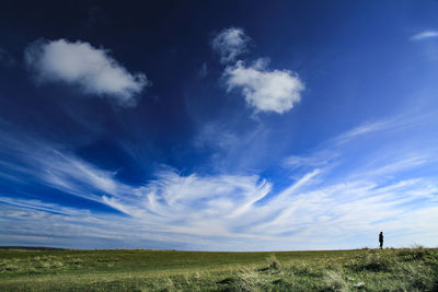 Scenic view of landscape against blue sky