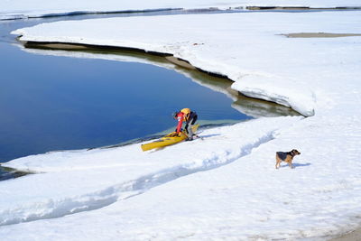 Man skiing on snow covered field