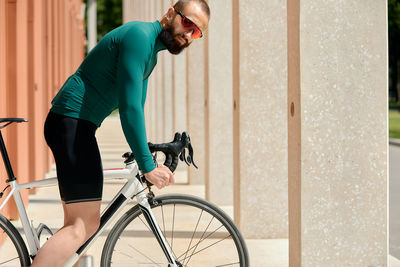 Side view of man riding bicycle