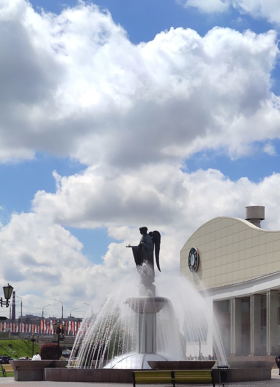 cloud, architecture, sky, fountain, built structure, water, building exterior, statue, nature, city, sculpture, motion, spraying, travel destinations, day, landmark, water feature, travel, monument, representation, outdoors, tourism, building, human representation, arts culture and entertainment