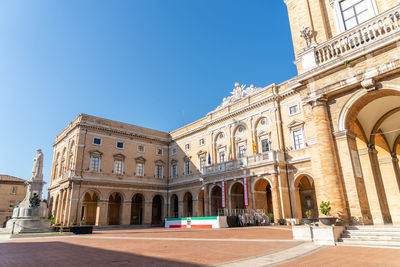 Low angle view of historical building against clear blue sky