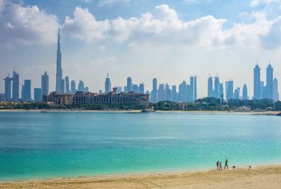 View of sea and buildings against sky