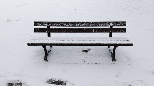 Close-up of bench on snow