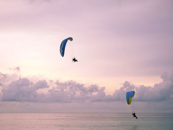 Powered paragliding or paramotor over the sea in evening