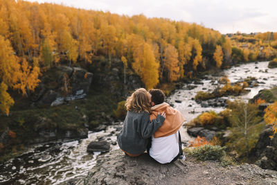 Happy people in love are travel hike in nature in the autumn forest. romantic trip to countryside