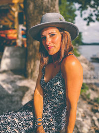 Portrait of woman wearing hat standing outdoors