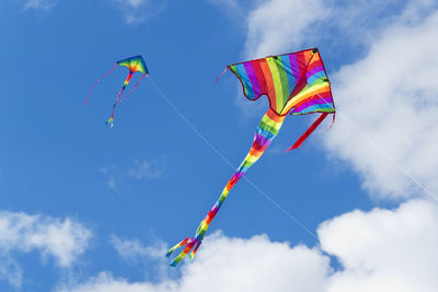 Low angle view of kite flying against blue sky