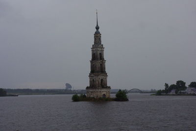 Old ruins of kalyazin bell tower amidst volga river against clear sky