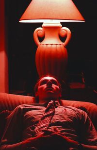 Portrait of man with red light at home