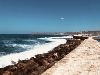 Scenic view of sea against clear blue sky