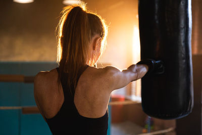 Rear view of woman exercising in gym
