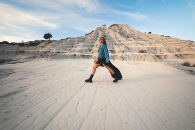 Full length of woman on land against sky