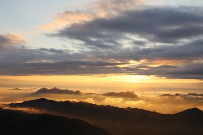 Scenic view of mountains against cloudy sky