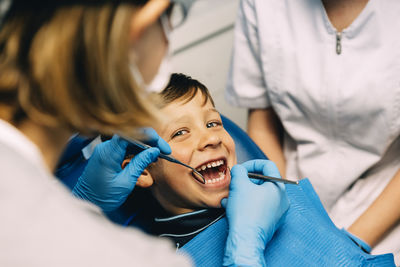 Dentist examining boy in medical clinic