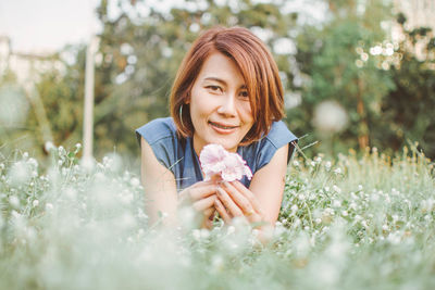 Portrait of woman resting on field