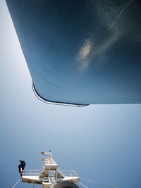 Low angle view of boat mast against blue sky