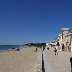 People on beach during sunny day