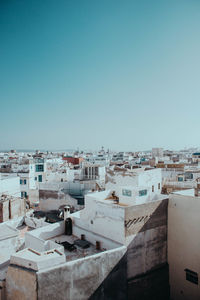 High angle view of buildings against clear blue sky