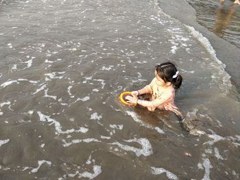 High angle view of man sitting in river