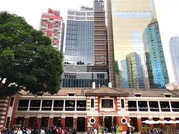 Buildings in city against clear sky