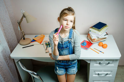 Girl holding book at home