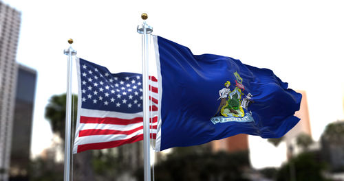 Low angle view of american flag against the sky