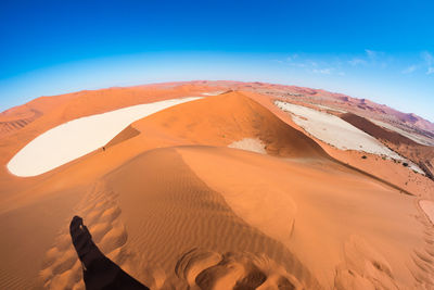 Scenic view of desert against blue sky