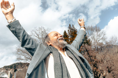 Portrait of a confident, handsome, mature man, pensioner, grandfather in the small town