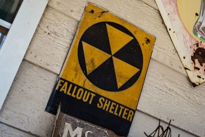 High angle view of yellow sign on metal