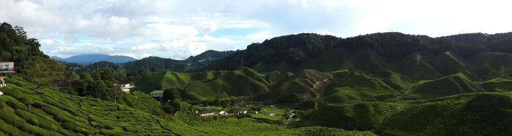 Scenic view of mountains against cloudy sky