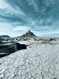 Scenic view of arid landscape against sky