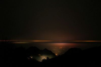 Scenic view of landscape against sky at night