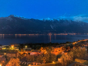 Scenic view of lake and mountains against blue sky