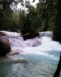 Scenic view of river flowing through rocks