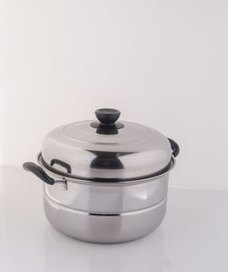 Close-up of steel cooking pot on white background