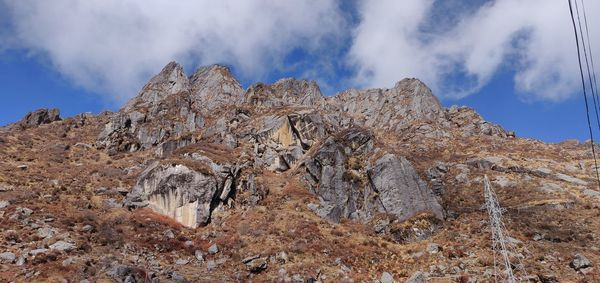 Low angle view of rock formation against sky