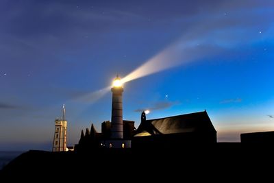 Low angle view of illuminated building against sky at night