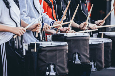 Bass drums of a marching band drum line warming up for a rehearsal