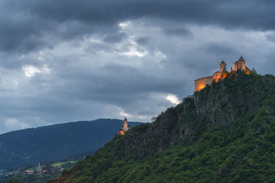 Panoramic view of buildings against cloudy sky