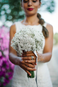 Close-up of bride holding flowers