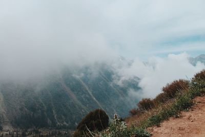 Scenic view of mountains against sky during foggy weather
