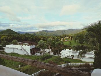 Scenic view of trees and mountains against sky