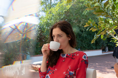 Beautiful women drinking coffee at outdoor cafe 